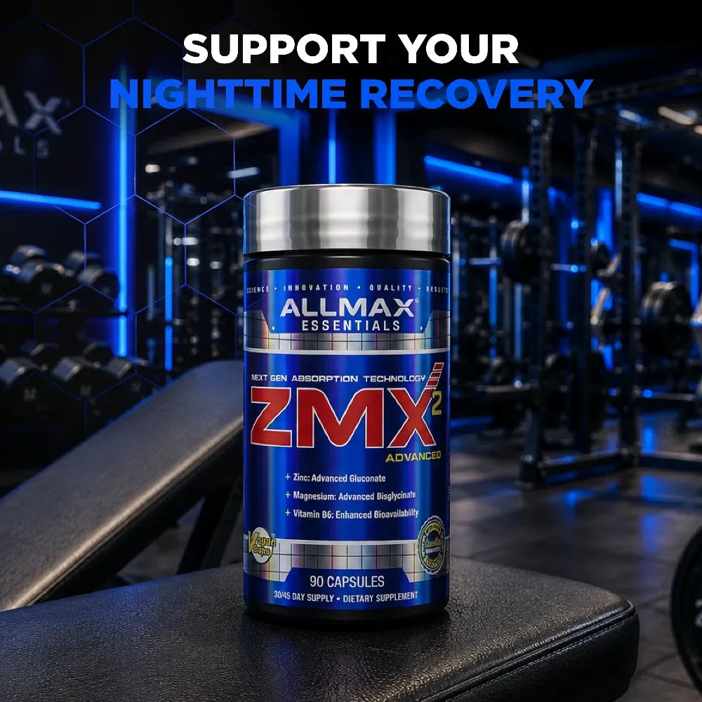 A bottle of Allmax Essentials ZMX Advanced dietary supplement placed on a gym bench with a blurred gym background featuring blue lighting. The text 'SUPPORT YOUR NIGHTTIME RECOVERY' is displayed at the top.