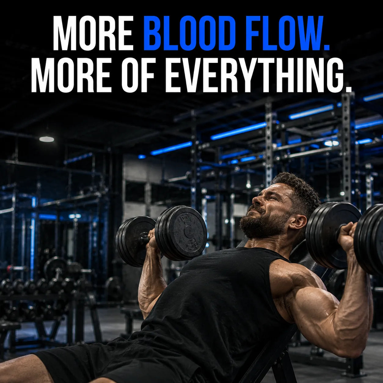 A muscular man in a black tank top and shorts performs a bench press with dumbbells in a dark gym with blue lighting, with the text 'MORE BLOOD FLOW. MORE OF EVERYTHING.