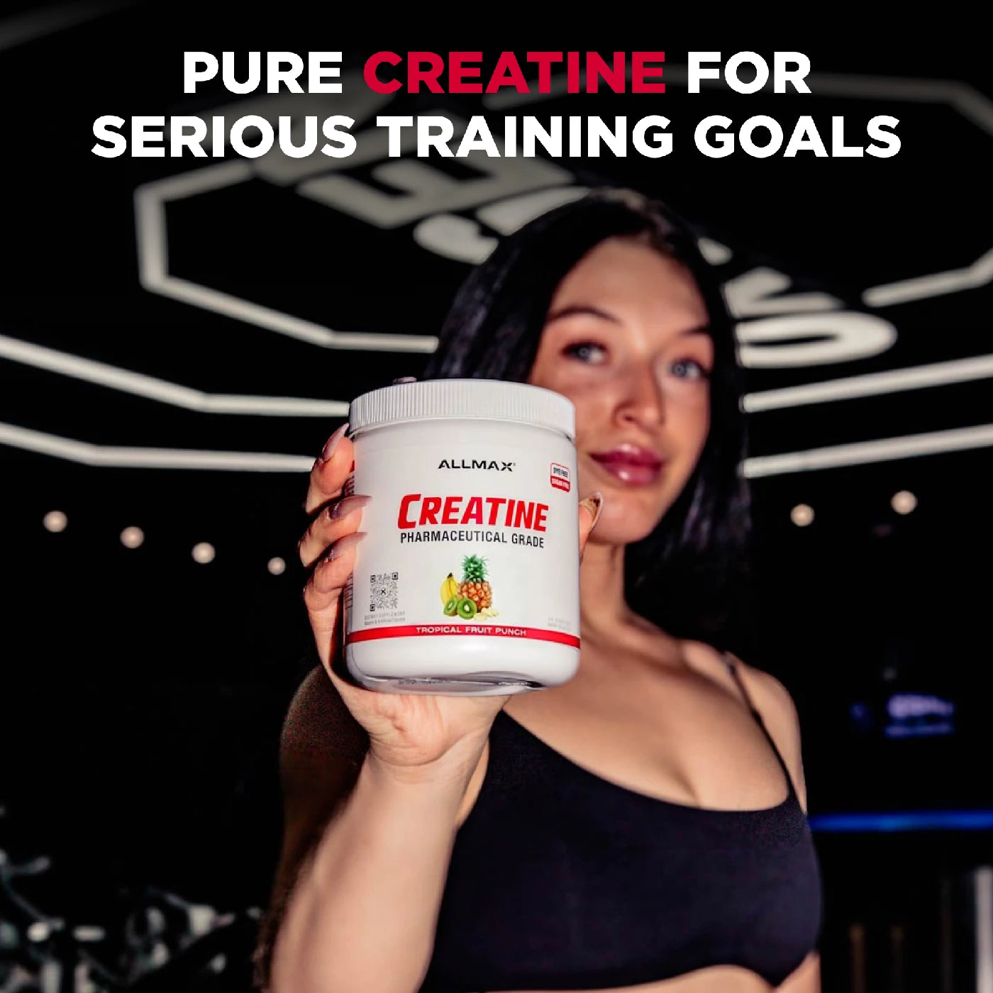 Person holding a container of Allmax Creatine with text about pure creatine for serious training goals.