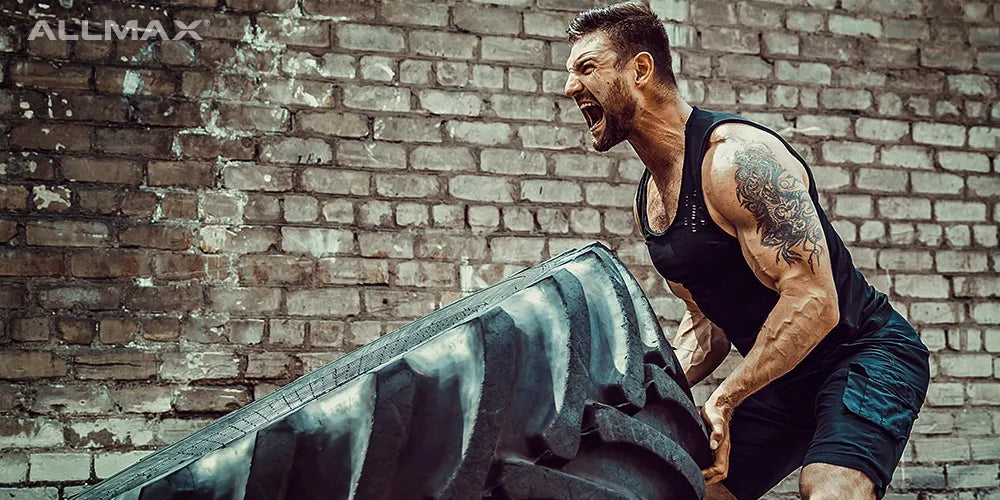 a man flipping a tire