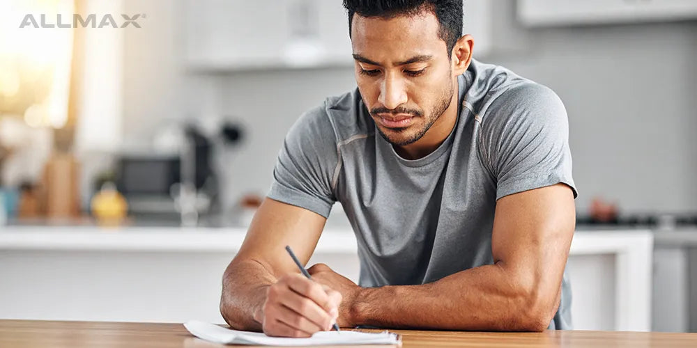 a man writing out a meal plan 