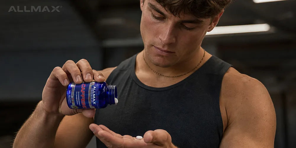 a man taking ALLMAX caffeine tabs