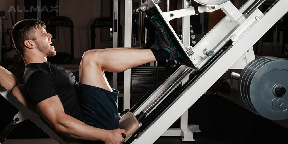 a man using a leg press machine