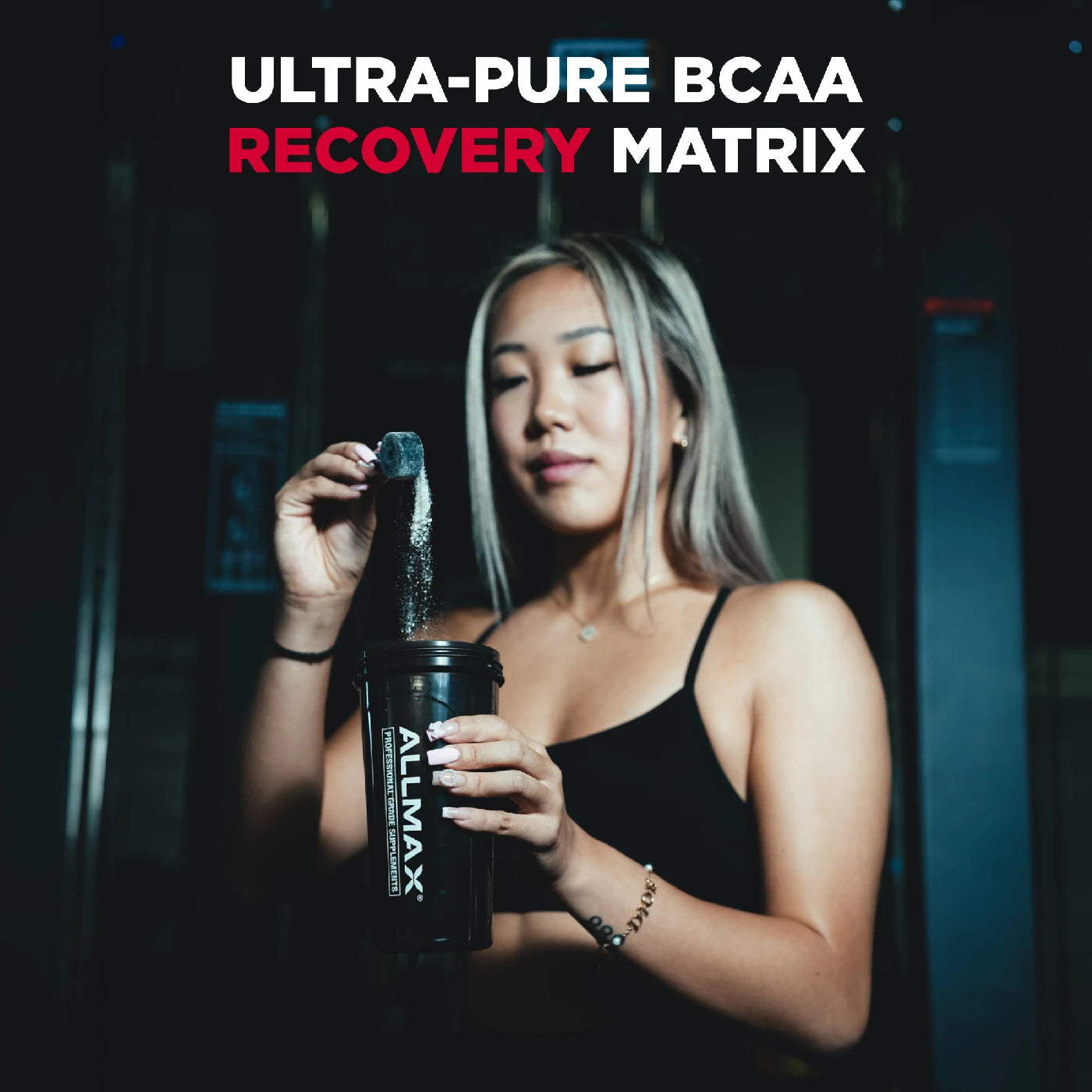 Woman holding a supplement bottle with 'Allmax' branding and text about Ultra-Pure BCAA Recovery Matrix.