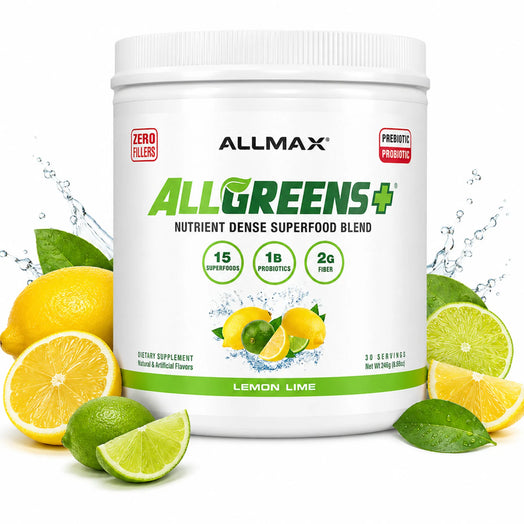 A white tub of ALLMAX AllGreens+ dietary supplement powder, lemon lime flavor, surrounded by fresh lemons and limes on a white background with water splash graphics.
